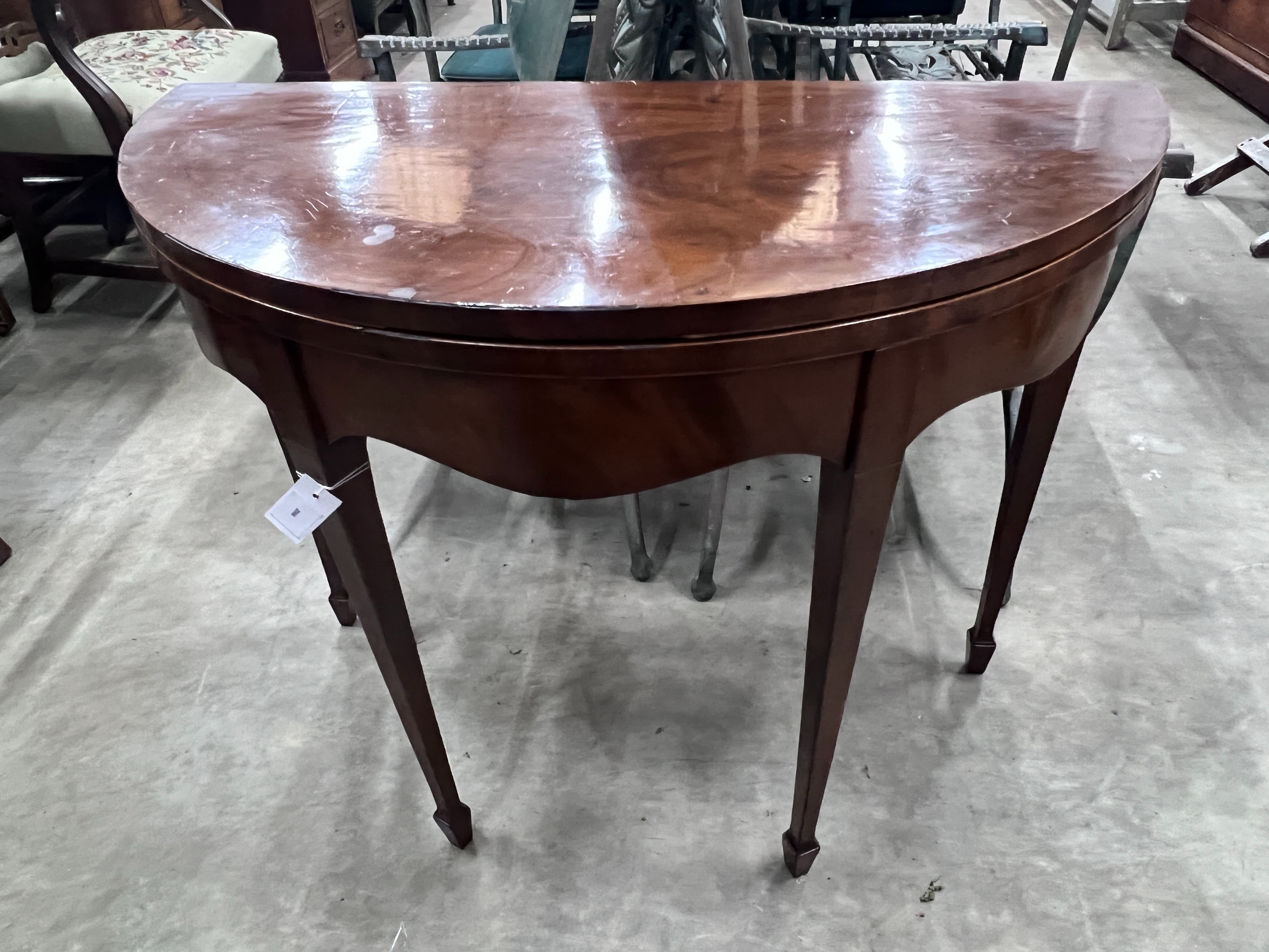 A George III mahogany demi-lune folding tea table, width 92cm, depth 45cm, height 74cm